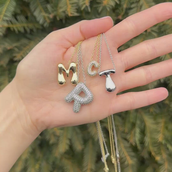 Hailey Bieber-inspired bubble letter initial necklace made from high-quality sterling silver, offering a stylish and durable way to personalize your look with a trendy and chic design. Perfect for layering or solo wear.